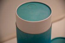 A closeup of scatter tube with a blue cascade design