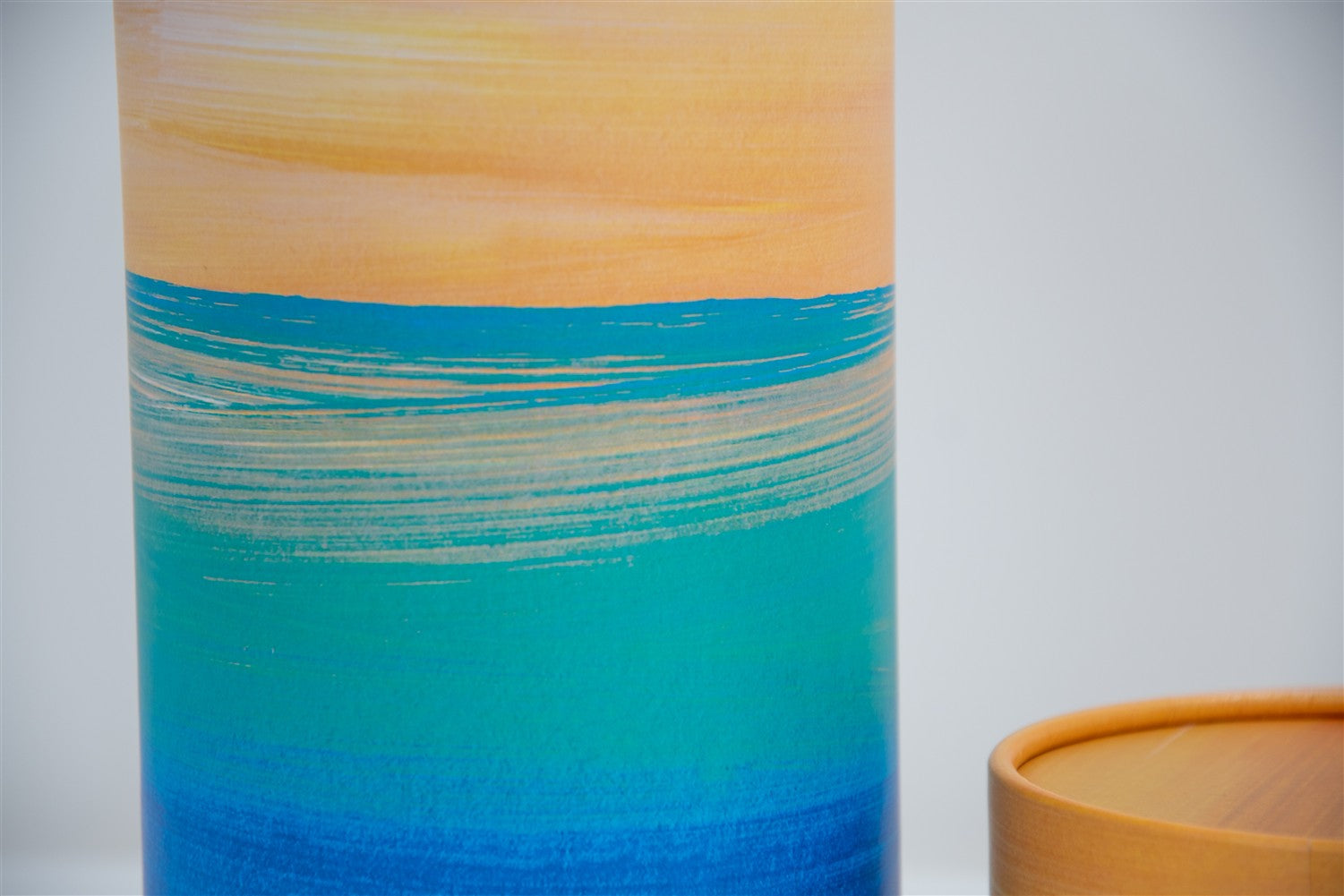 A closeup of scatter tube with a golden tides design