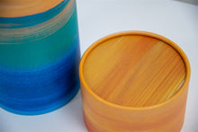A closeup of scatter tube with a golden tides design
