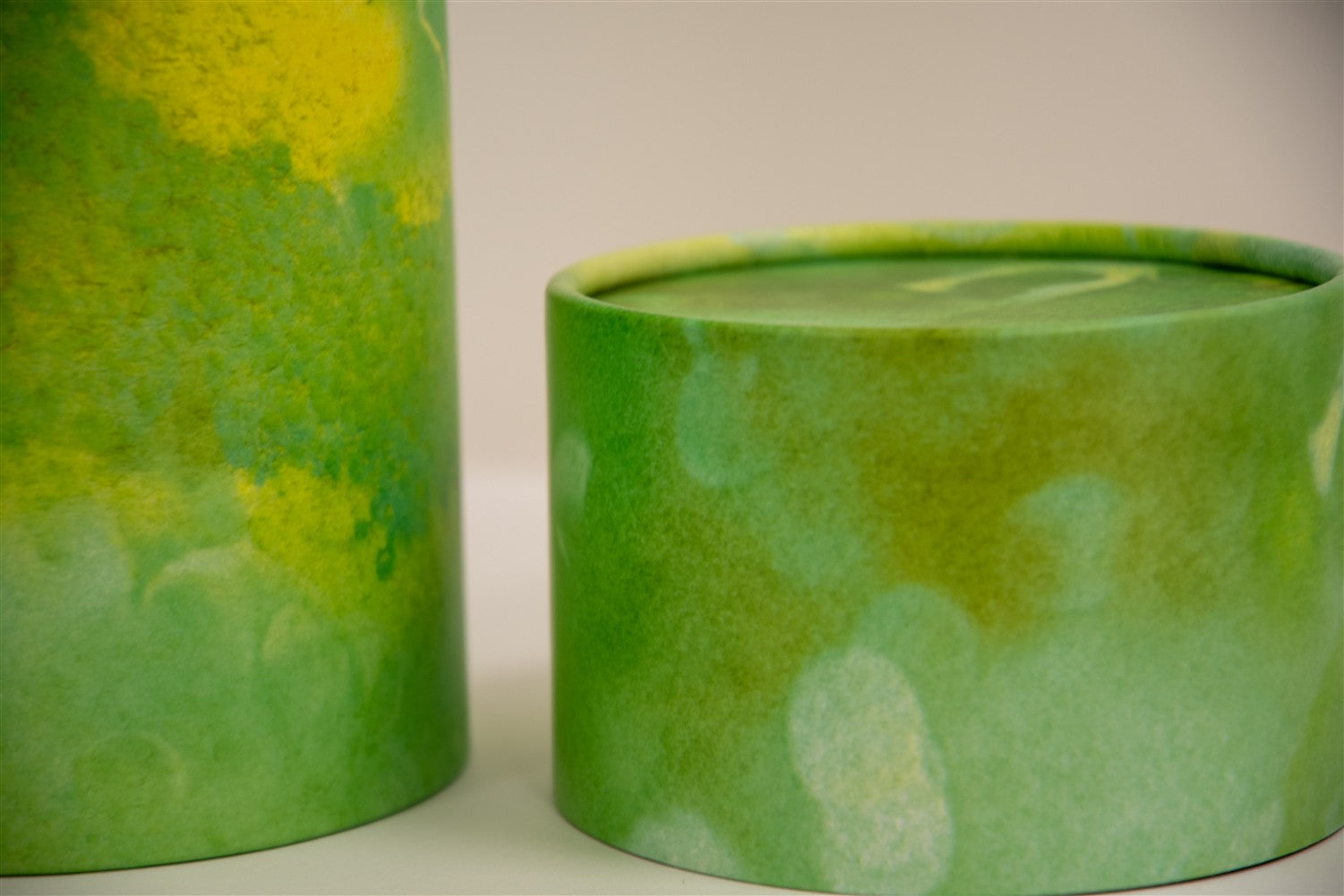 A closeup of scatter tube with a green verdant design
