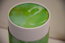 A closeup of scatter tube with a green verdant design