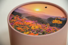 A closeup of scatter tube with a meadow design