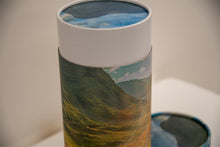 A closeup of scatter tube with a mountains design