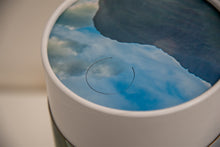 A closeup of scatter tube with a mountains design