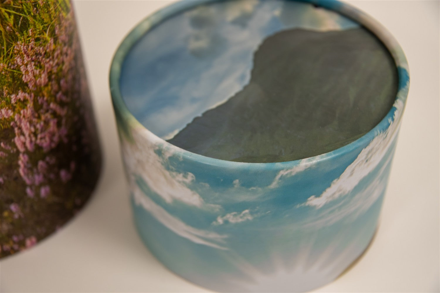 A closeup of scatter tube with a mountains design