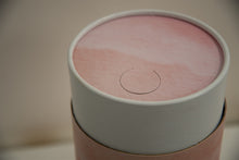 A closeup of scatter tube with a pink skies design