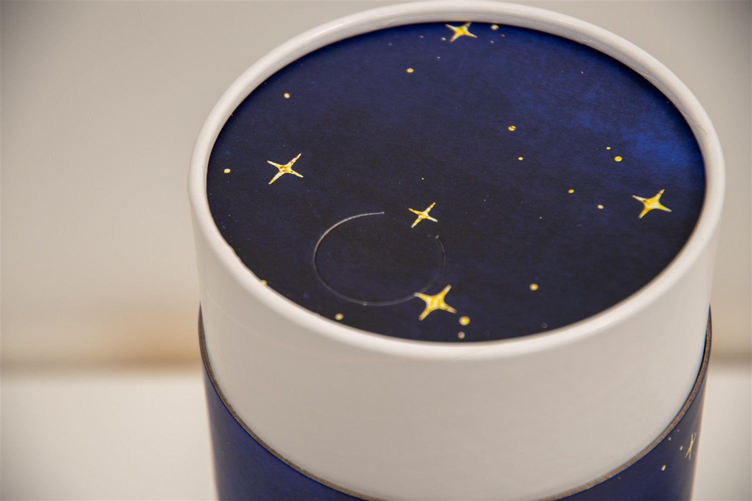 A closeup of a scatter tube with a starry night painting design