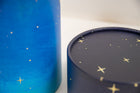 A closeup of scatter tube with a starry night painting design