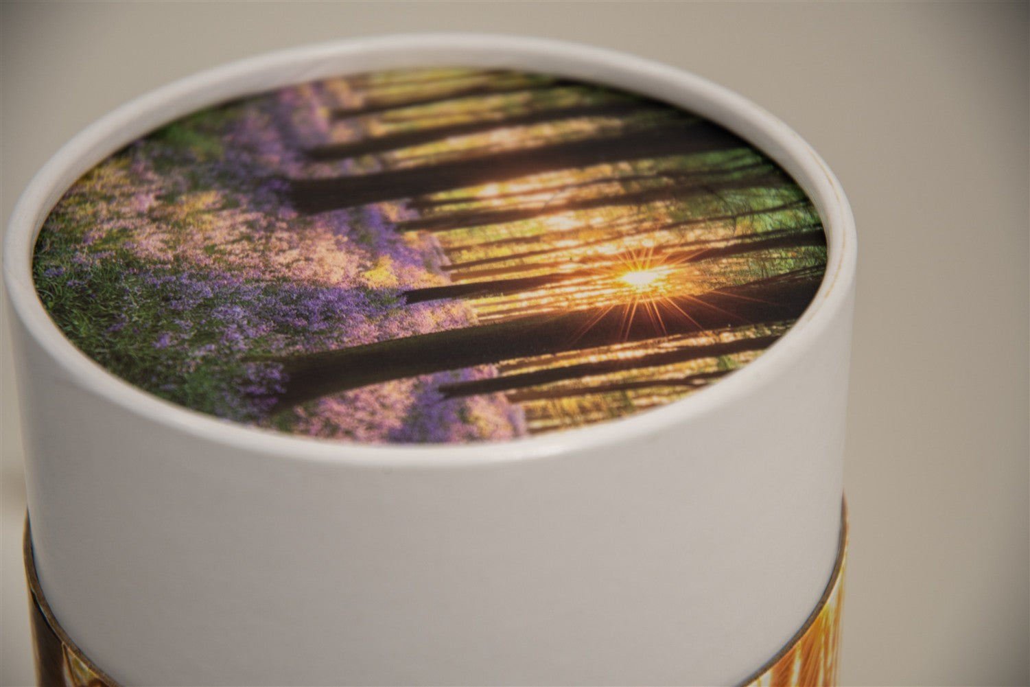 A closeup of a scatter tube with a woodland design