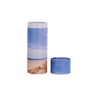 A scatter tube with a beach design showing the lid removed