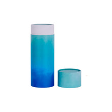 A scatter tube with a blue cascade design showing lid removed