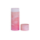 A scatter tube with the lid removed showing a pink skies design